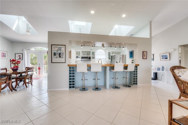 3025 Turtle Gait Ln, Sanibel, FL 33957 - living area with light tile patterned floors, baseboards, and rail lighting