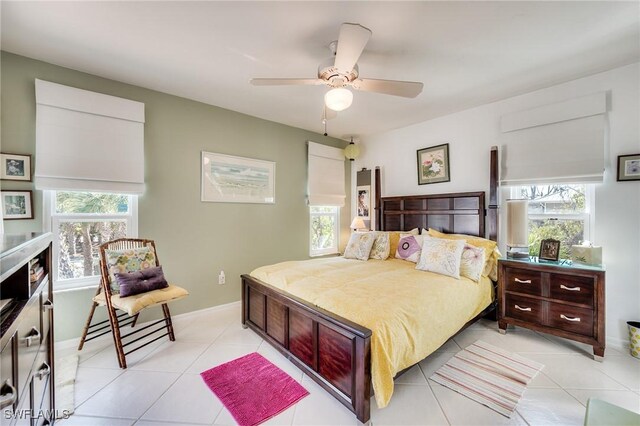 3025 Turtle Gait Ln, Sanibel, FL 33957 - bedroom with light tile patterned floors, ceiling fan, and multiple windows