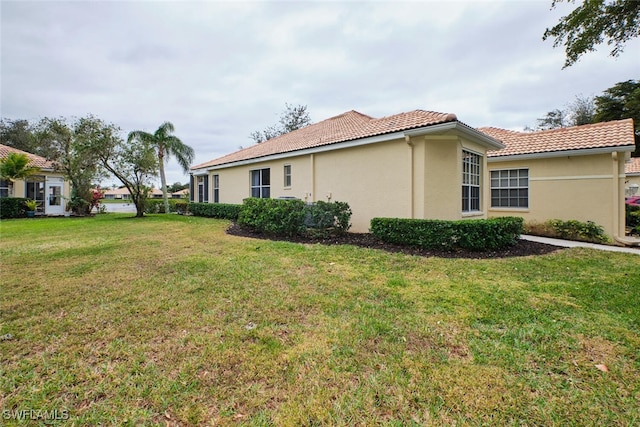 view of property exterior featuring a lawn