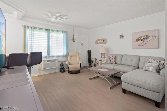 living room featuring a wall mounted air conditioner, ornamental molding, and wood-type flooring