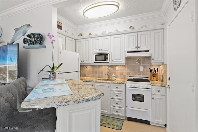 kitchen with sink, white cabinets, white appliances, and decorative backsplash