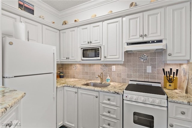 kitchen with white cabinetry, white appliances, sink, and tasteful backsplash