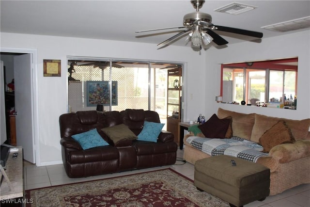 tiled living room with ceiling fan