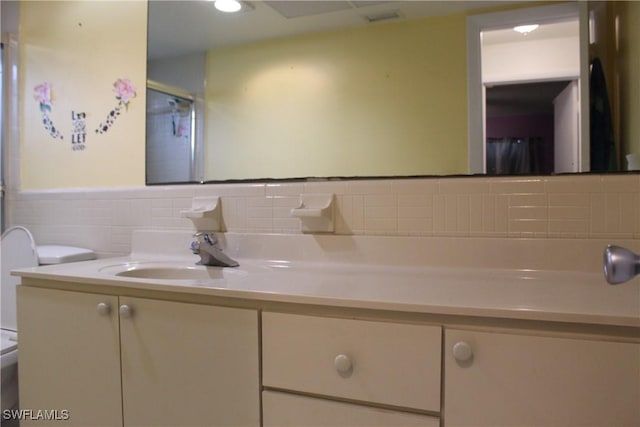 bathroom featuring vanity, toilet, and a shower with shower door