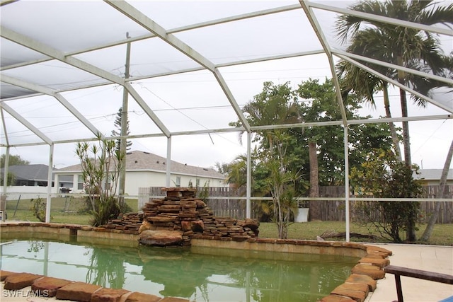 view of swimming pool with glass enclosure