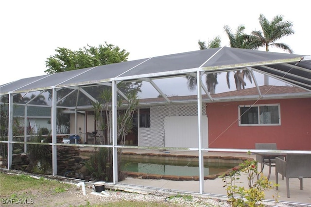 view of home's exterior featuring glass enclosure