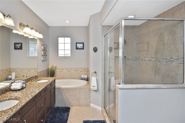 bathroom featuring tile patterned flooring, vanity, and separate shower and tub