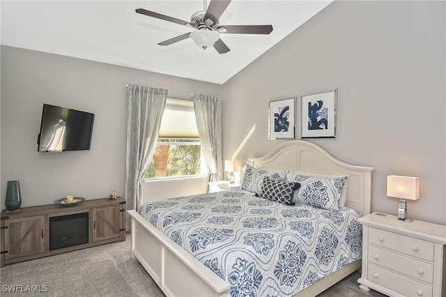 carpeted bedroom featuring vaulted ceiling and ceiling fan