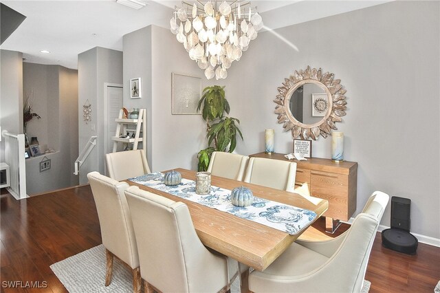 dining area featuring dark hardwood / wood-style flooring and a chandelier