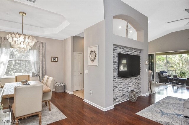 dining area featuring wood-type flooring and ceiling fan with notable chandelier