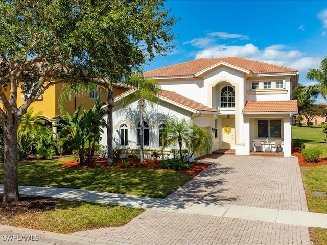 mediterranean / spanish house with a front lawn