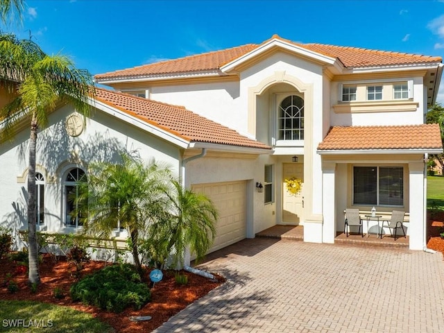 rear view of property with a garage