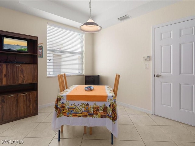 dining space featuring light tile patterned floors