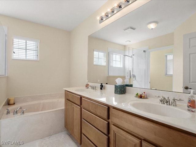 bathroom featuring independent shower and bath, vanity, and tile patterned flooring