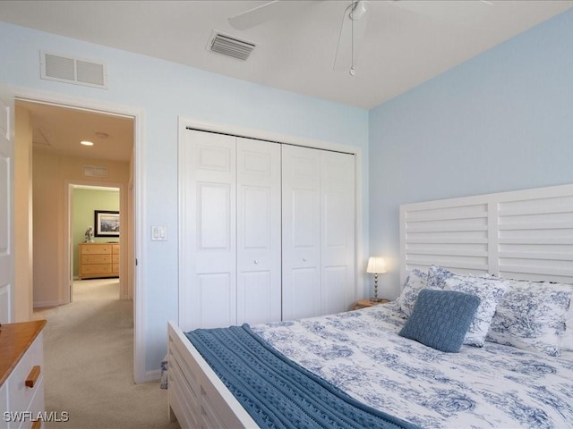 carpeted bedroom with a closet and ceiling fan