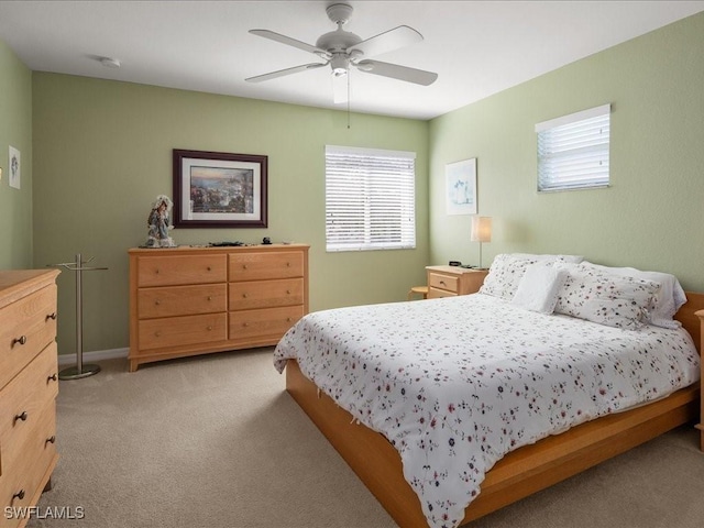 bedroom with ceiling fan and light colored carpet