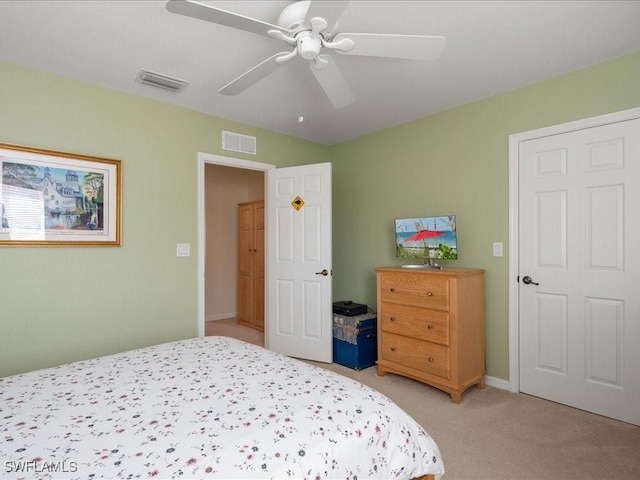 bedroom with light carpet and ceiling fan