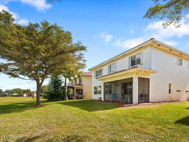 back of house featuring a lawn