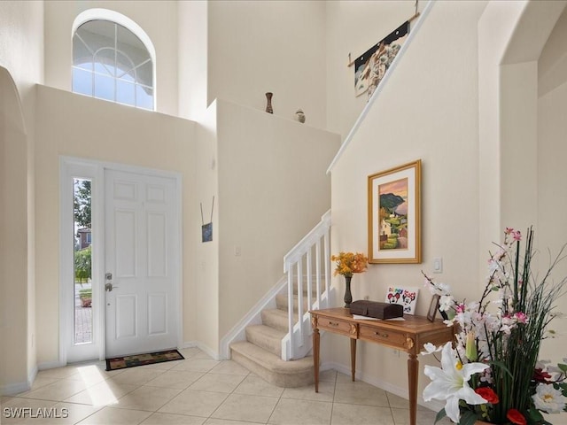 tiled foyer entrance with plenty of natural light and a high ceiling