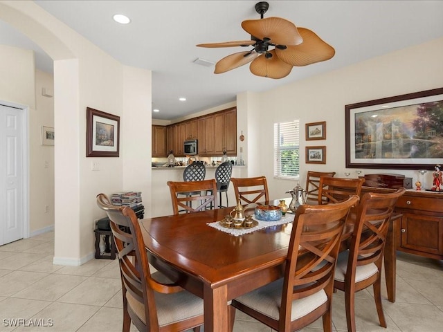 dining space with light tile patterned floors and ceiling fan