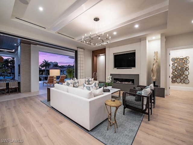 living room featuring beam ceiling, a chandelier, and light wood-type flooring