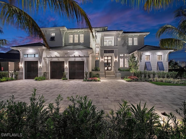 3637 Crayton Rd, Naples, FL 34103 - view of front of property featuring driveway, an attached garage, french doors, and stucco siding