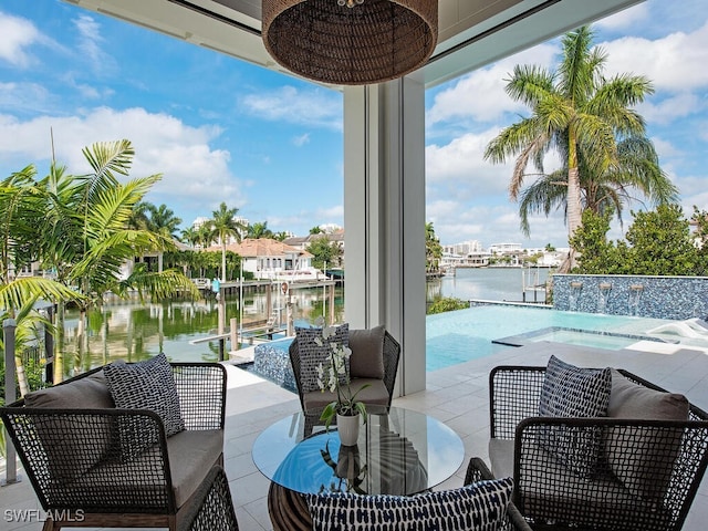 view of patio / terrace with pool water feature, a boat dock, and a water view