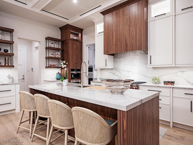 3637 Crayton Rd, Naples, FL 34103 - kitchen featuring light wood finished floors, light stone countertops, decorative backsplash, open shelves, and white cabinets