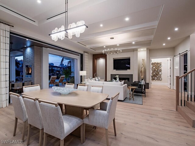 3637 Crayton Rd, Naples, FL 34103 - dining room with a chandelier, recessed lighting, light wood-style flooring, and a fireplace