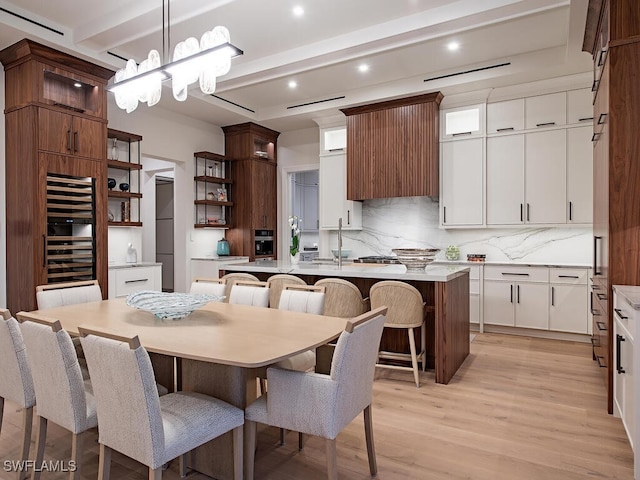3637 Crayton Rd, Naples, FL 34103 - dining space with beamed ceiling, light wood finished floors, recessed lighting, a chandelier, and beverage cooler