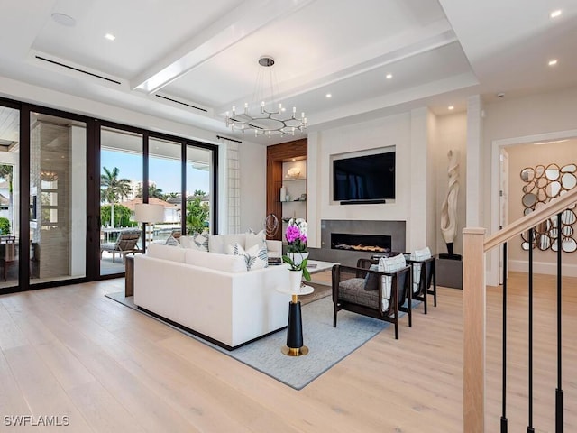 3637 Crayton Rd, Naples, FL 34103 - living room featuring a fireplace, light wood-type flooring, recessed lighting, and a notable chandelier