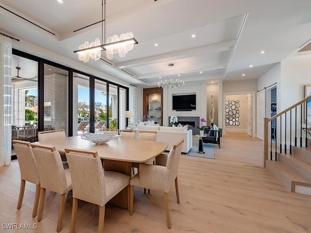 3637 Crayton Rd, Naples, FL 34103 - dining area featuring recessed lighting, a notable chandelier, light wood-style floors, and a fireplace