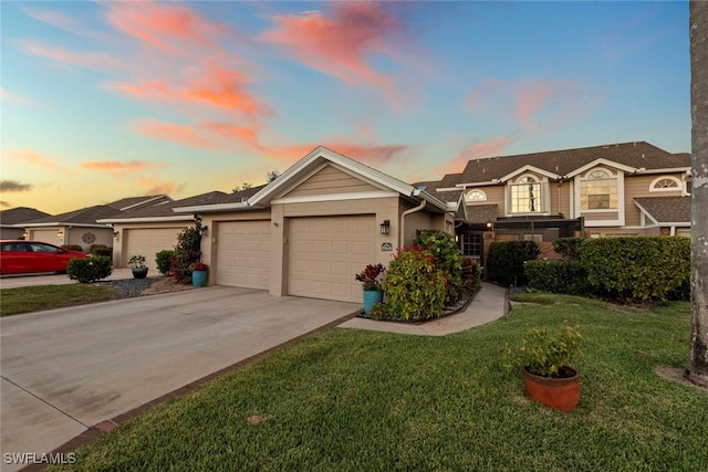 view of front of property with a garage, concrete driveway, a lawn, and stucco siding