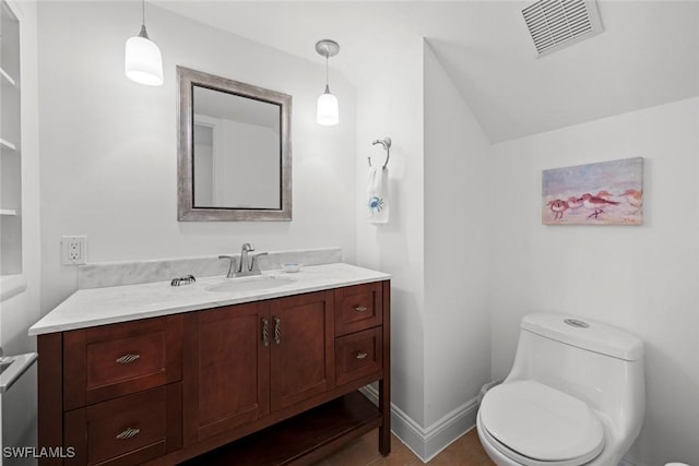 bathroom featuring toilet, baseboards, visible vents, and vanity