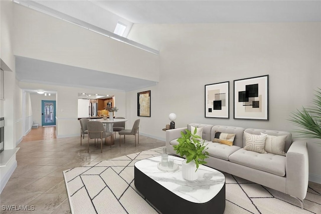 living area with high vaulted ceiling and baseboards