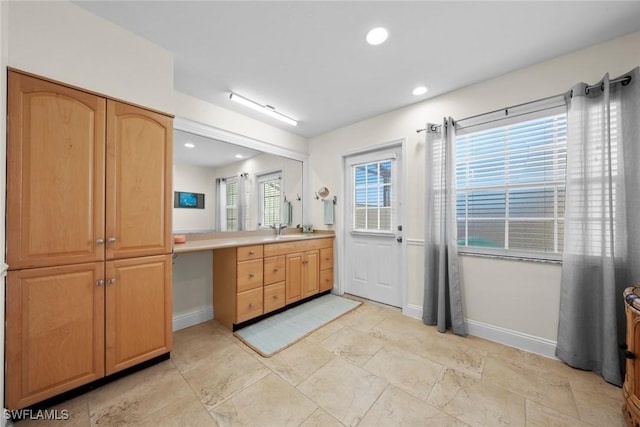 full bathroom with baseboards, vanity, and recessed lighting