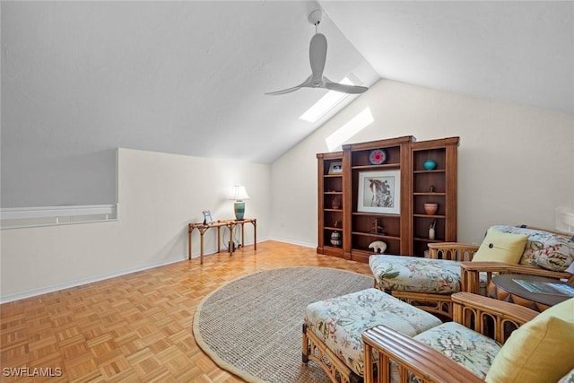 sitting room with light parquet floors, vaulted ceiling with skylight, and ceiling fan