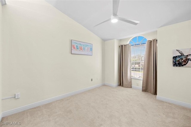 unfurnished bedroom with a ceiling fan, light carpet, vaulted ceiling, and baseboards