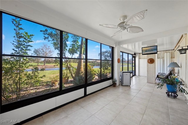 unfurnished sunroom with ceiling fan