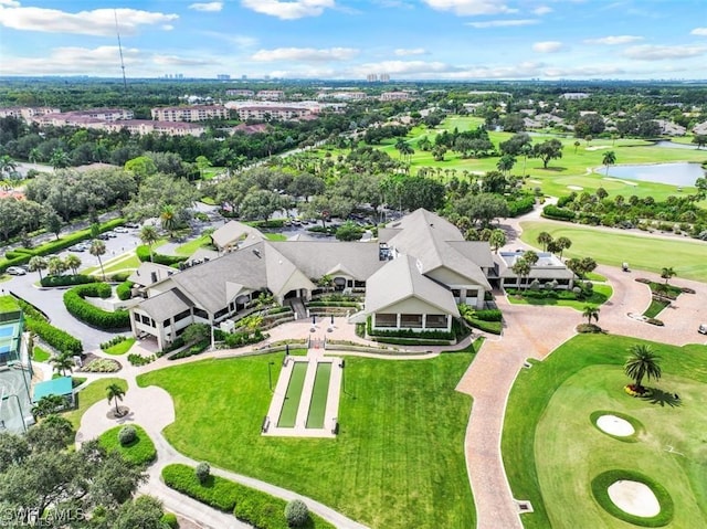 drone / aerial view with a water view and golf course view