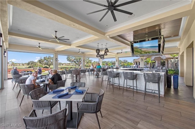 view of patio featuring a bar and ceiling fan