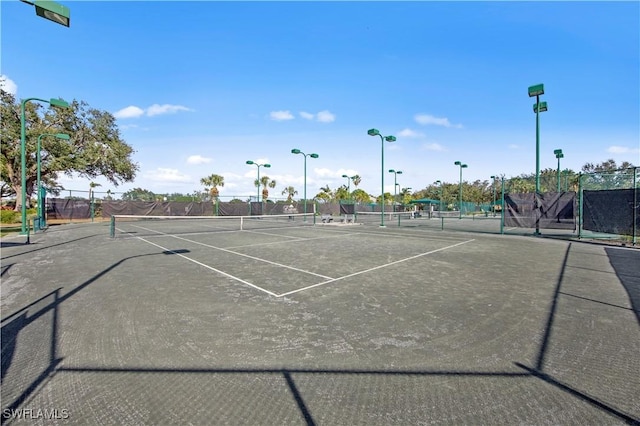 view of tennis court featuring fence