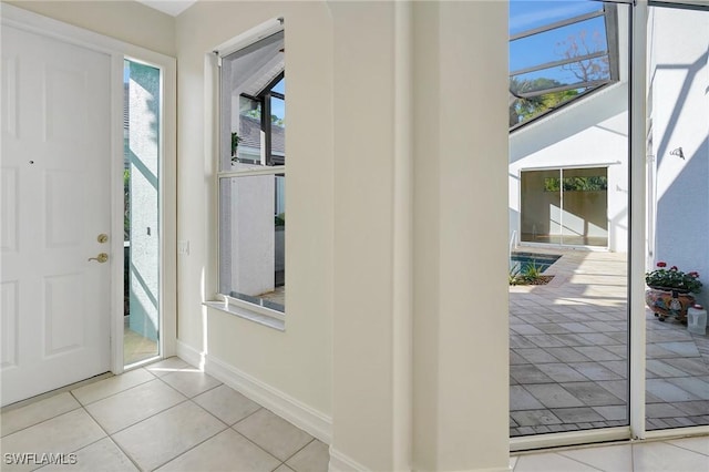 foyer featuring tile patterned flooring and baseboards