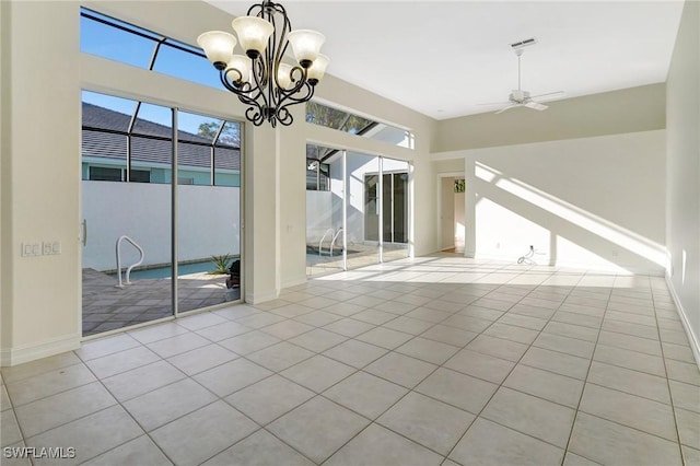 tiled empty room with baseboards, visible vents, and ceiling fan with notable chandelier