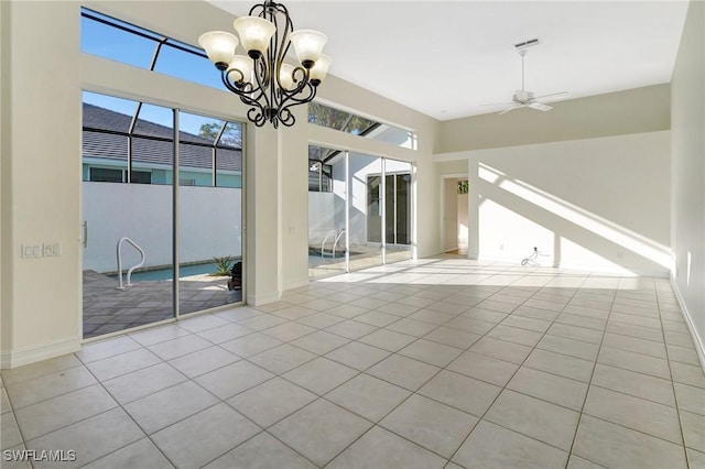 interior space with tile patterned floors, baseboards, and ceiling fan with notable chandelier