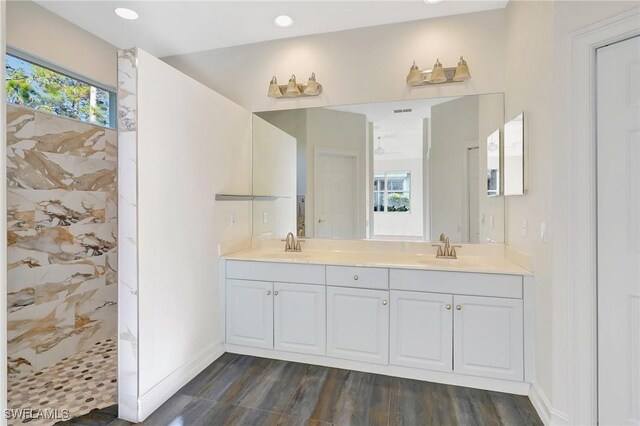 bathroom featuring wood-type flooring, vanity, and walk in shower