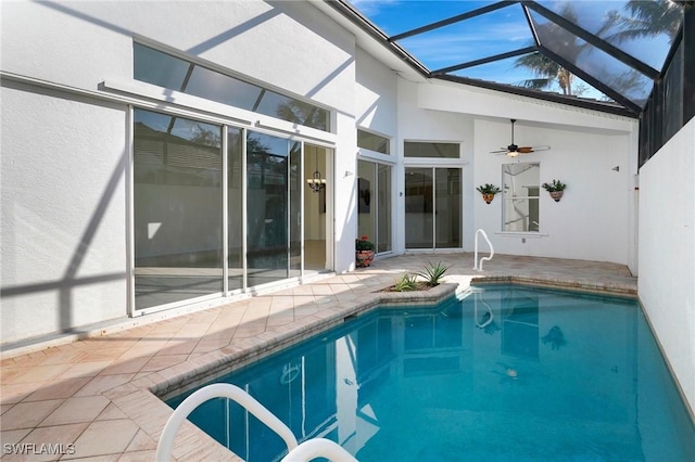 view of pool with ceiling fan, a lanai, and a patio area