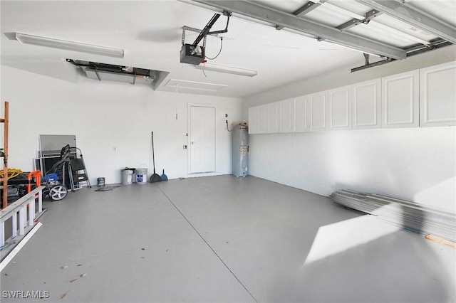 garage with a garage door opener and electric water heater