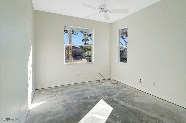 spare room with concrete flooring and ceiling fan