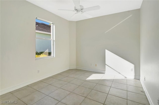 spare room with light tile patterned floors and ceiling fan